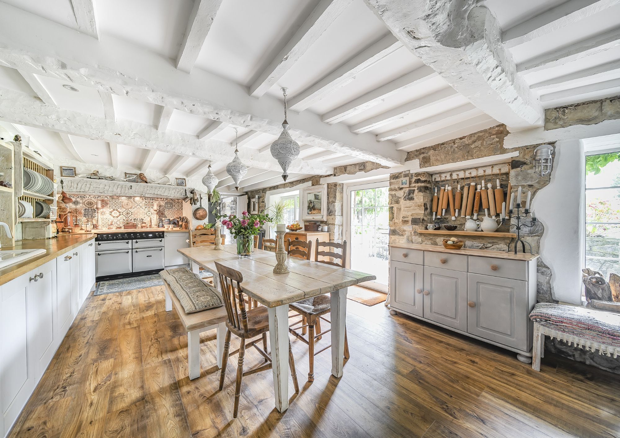 Large kitchen/diner in a period house with a neutral colour scheme and an Aga at one end.