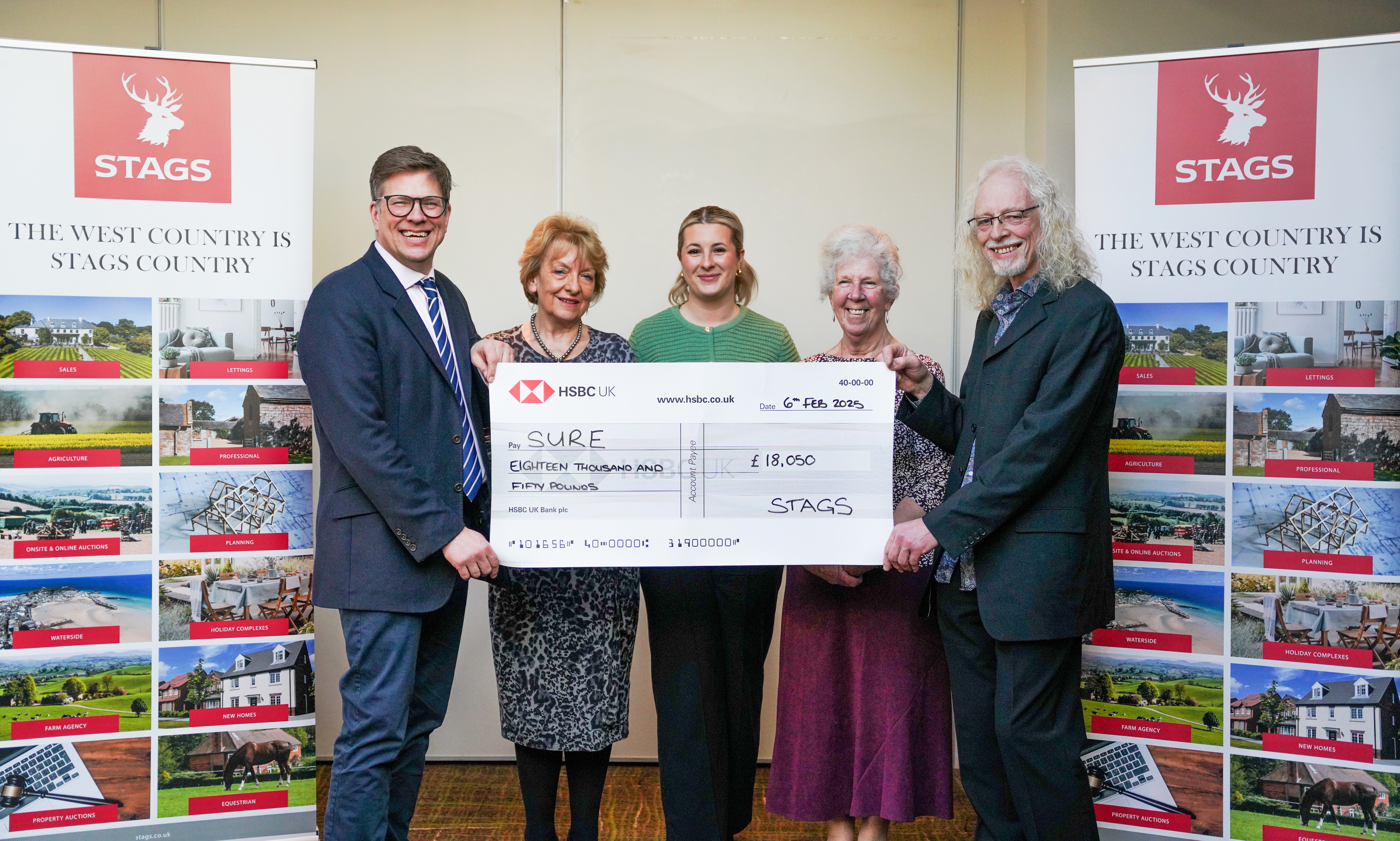 S.U.R.E. accepting the fundraising cheque from David and Lara from our Taunton Stags office.