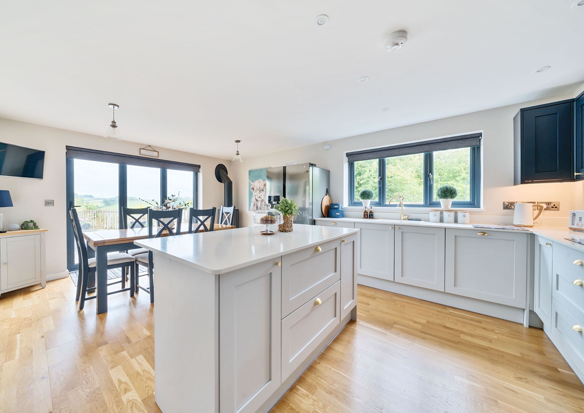 A modern, open plan kitchen/diner with bifold doors opening to the rear garden.