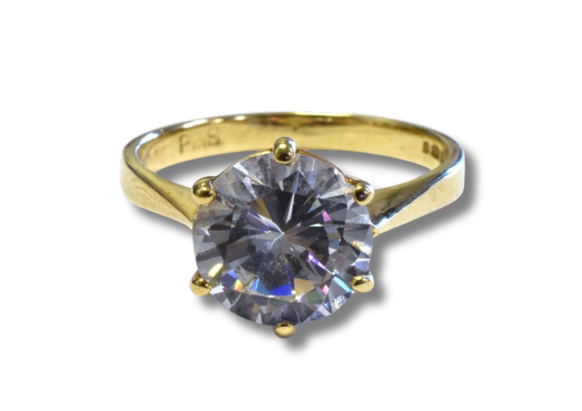 A nine carat gold ring with a round, claw set centre stone.