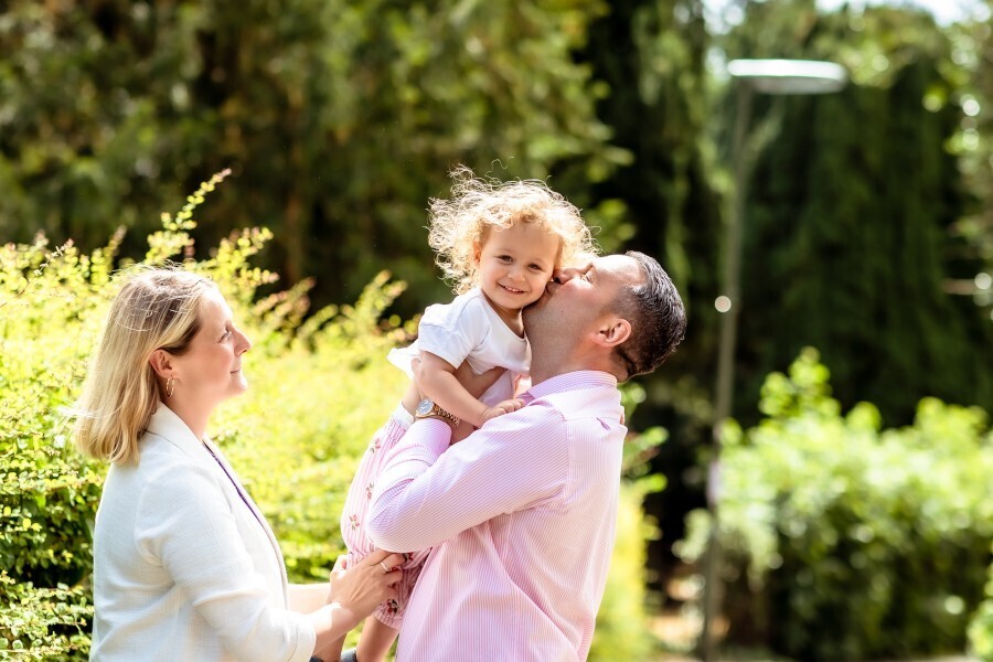 Photo of Stuart Benson holding up his daughter with his partner Francesca