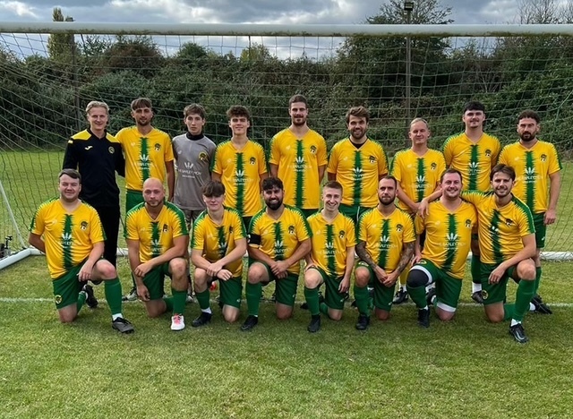 Photo of Hersham FC football team standing in the goal together