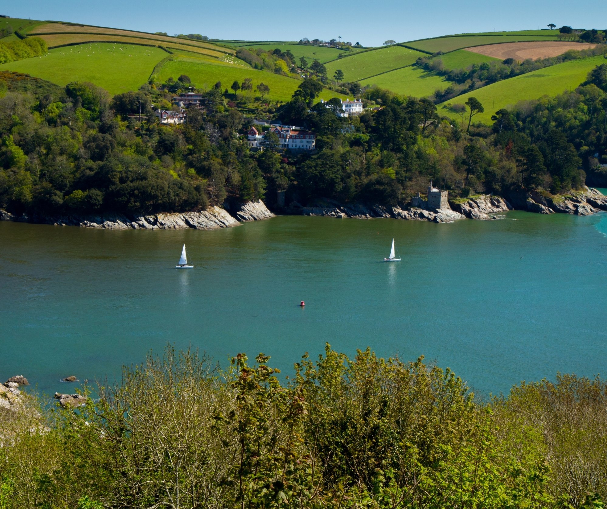 Aerial shot of the river dart with fishing boats and fields 