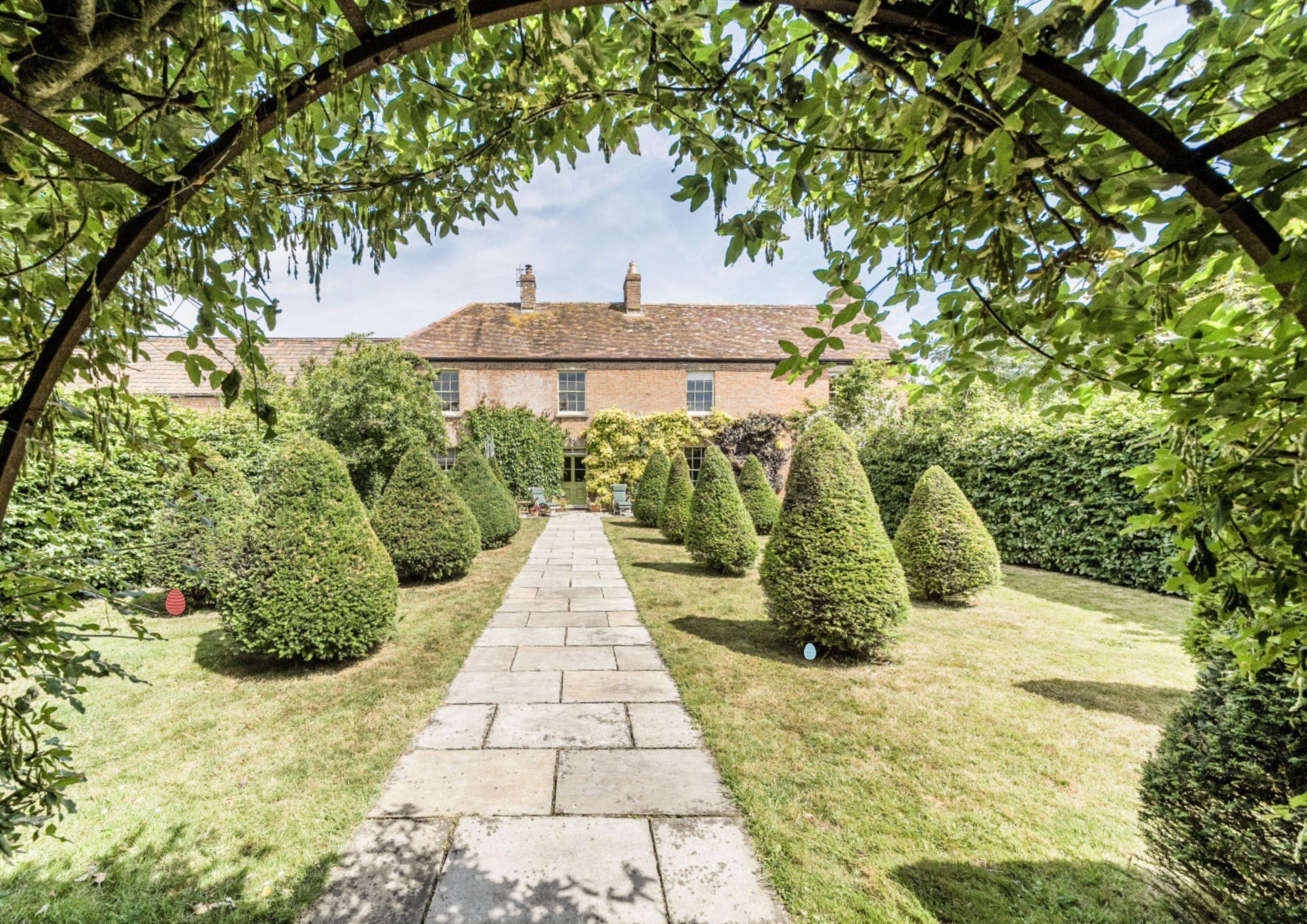Landscaped garden with path leading to large house
