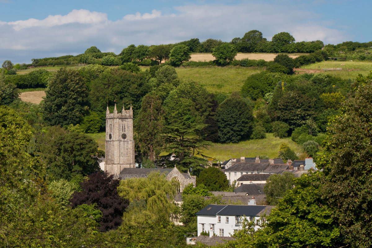 Ashburton Countryside with house and church peaking through the trees