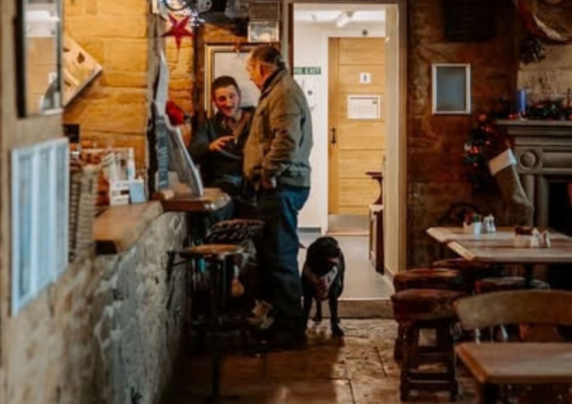 Two men and a dog at a country bar 