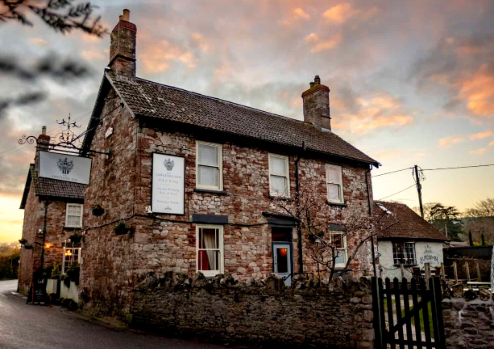 Country stone pub at sunset