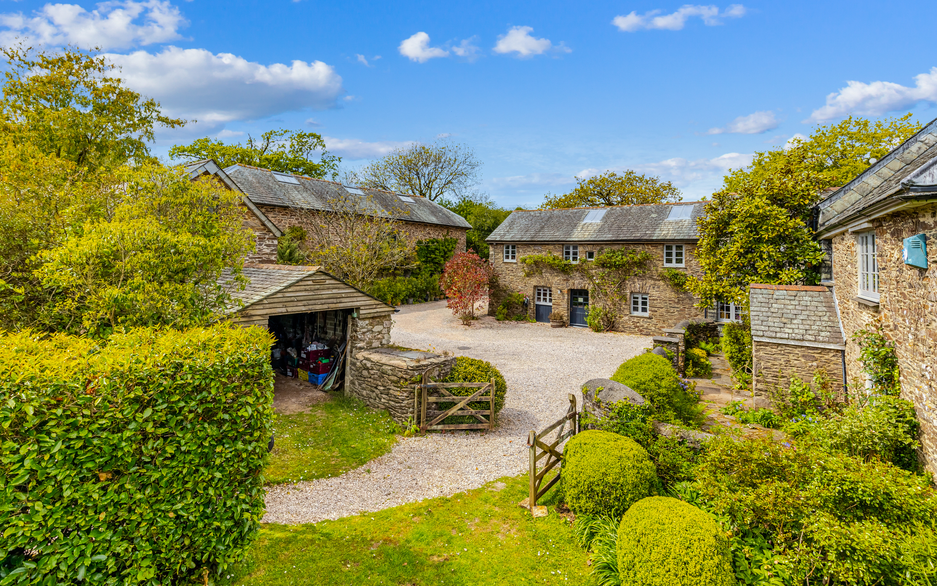 An estate of stone farmhouses surrounded by trees