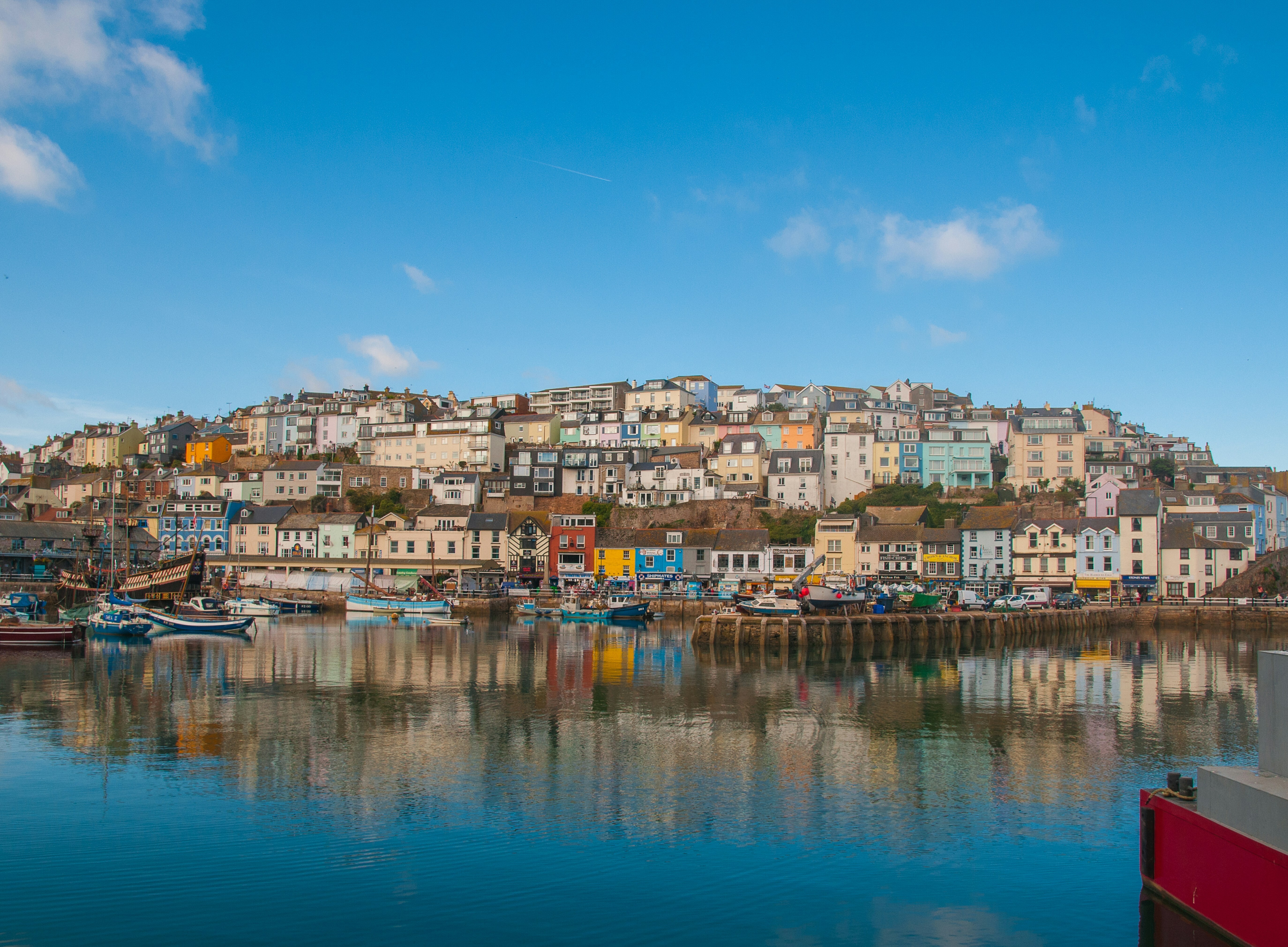 View of Brixham Harbour with it's colourful homes and buildings and relfections in the water
